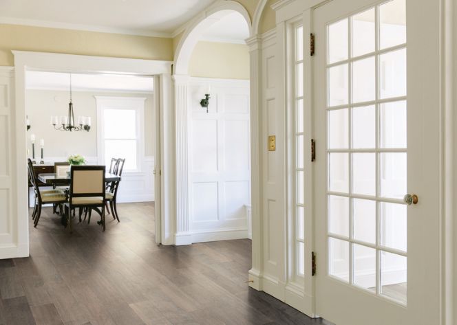 hardwood flooring in minimalist entryway and dining room