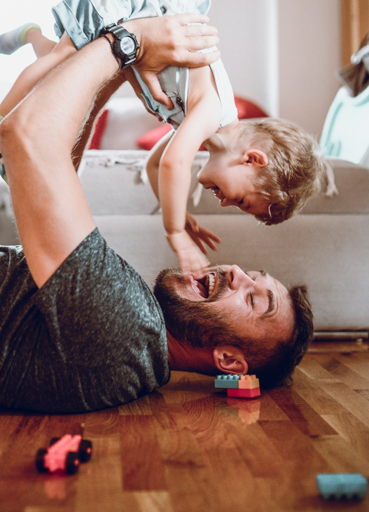 Dad playing with child on floor